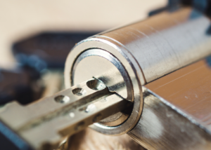 A close up of a key inserted into a cylinder lock.
